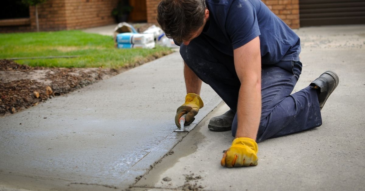 Concrete driveway with black strip expansion joint visible — Abshire Brothers Lawn & Landscape Rayne