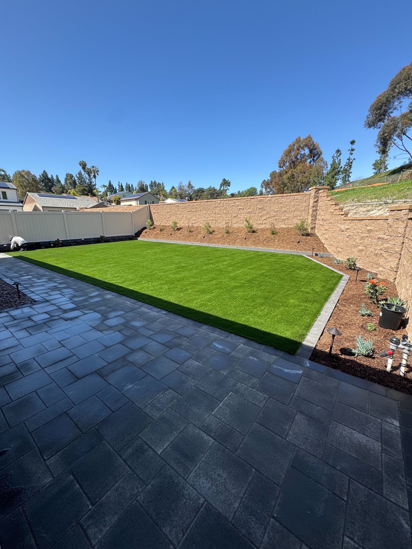 Luxury landscape design and installation with turf, pavers, and planting in Rayne by Abshire Brothers Lawn & Landscape
