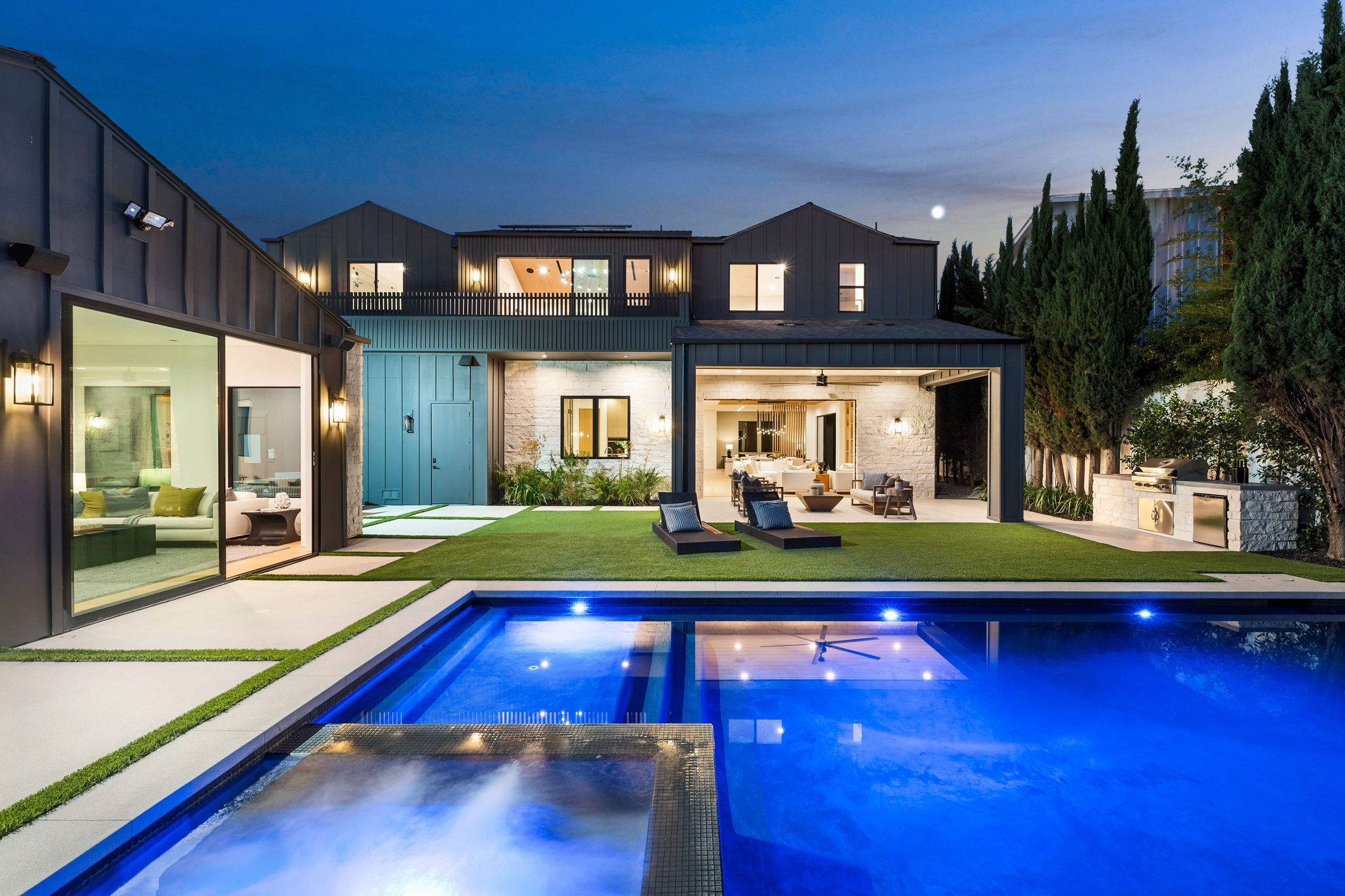 Completed luxury backyard remodel with pool, pavers, and outdoor living in Rayne by Abshire Brothers Lawn & Landscape
