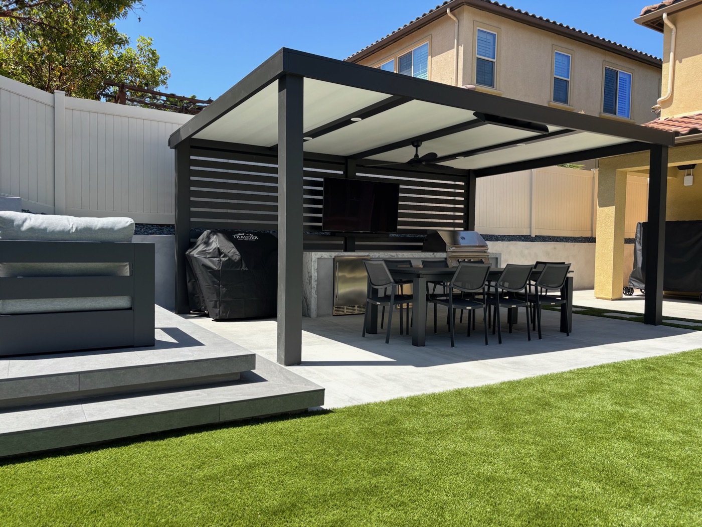 Louvered pergola dining and outdoor kitchen in Lafayette by Abshire Brothers Lawn & Landscape