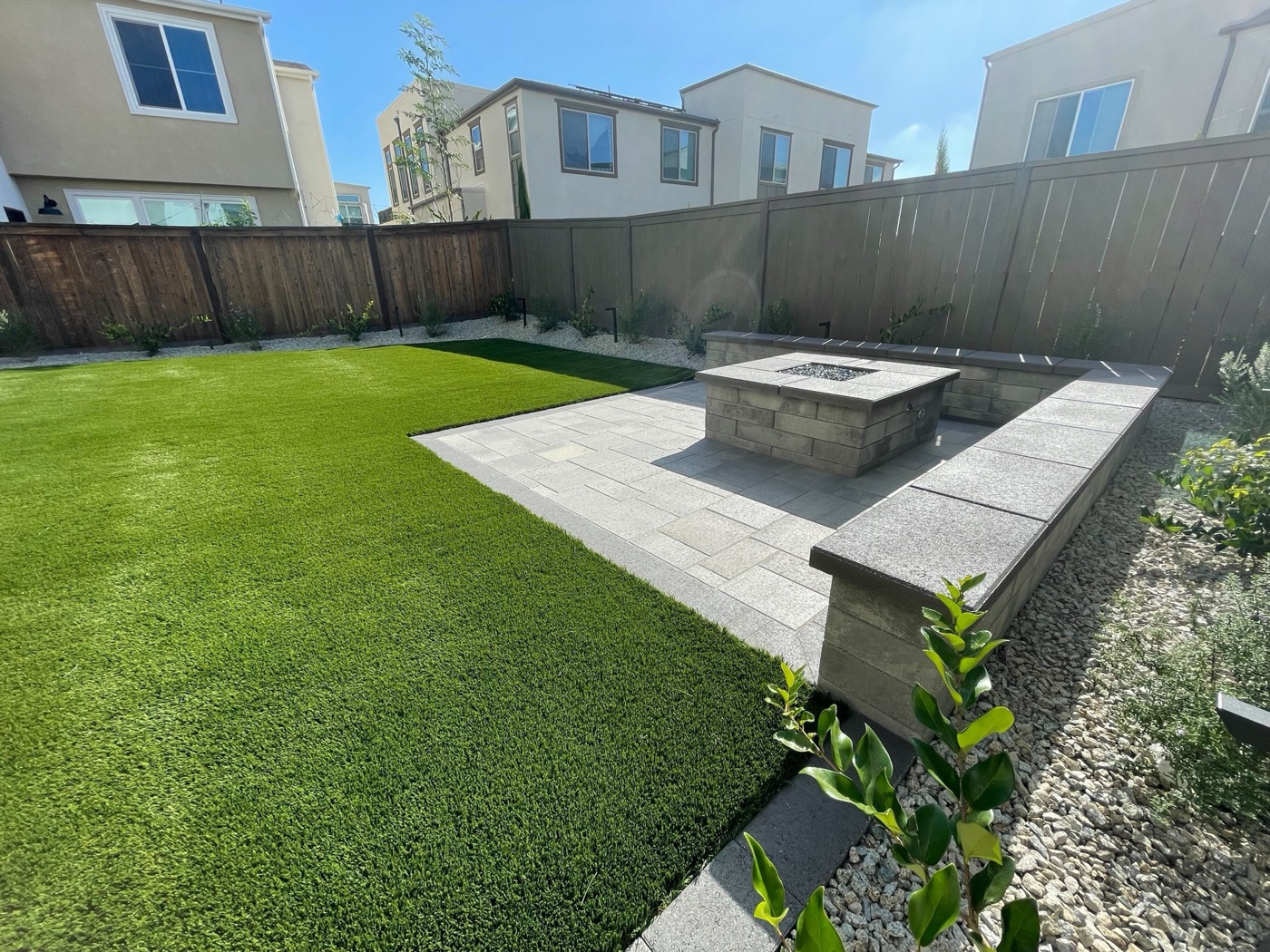 Fire pit and paver patio with lawn in Lafayette by Abshire Brothers Lawn & Landscape