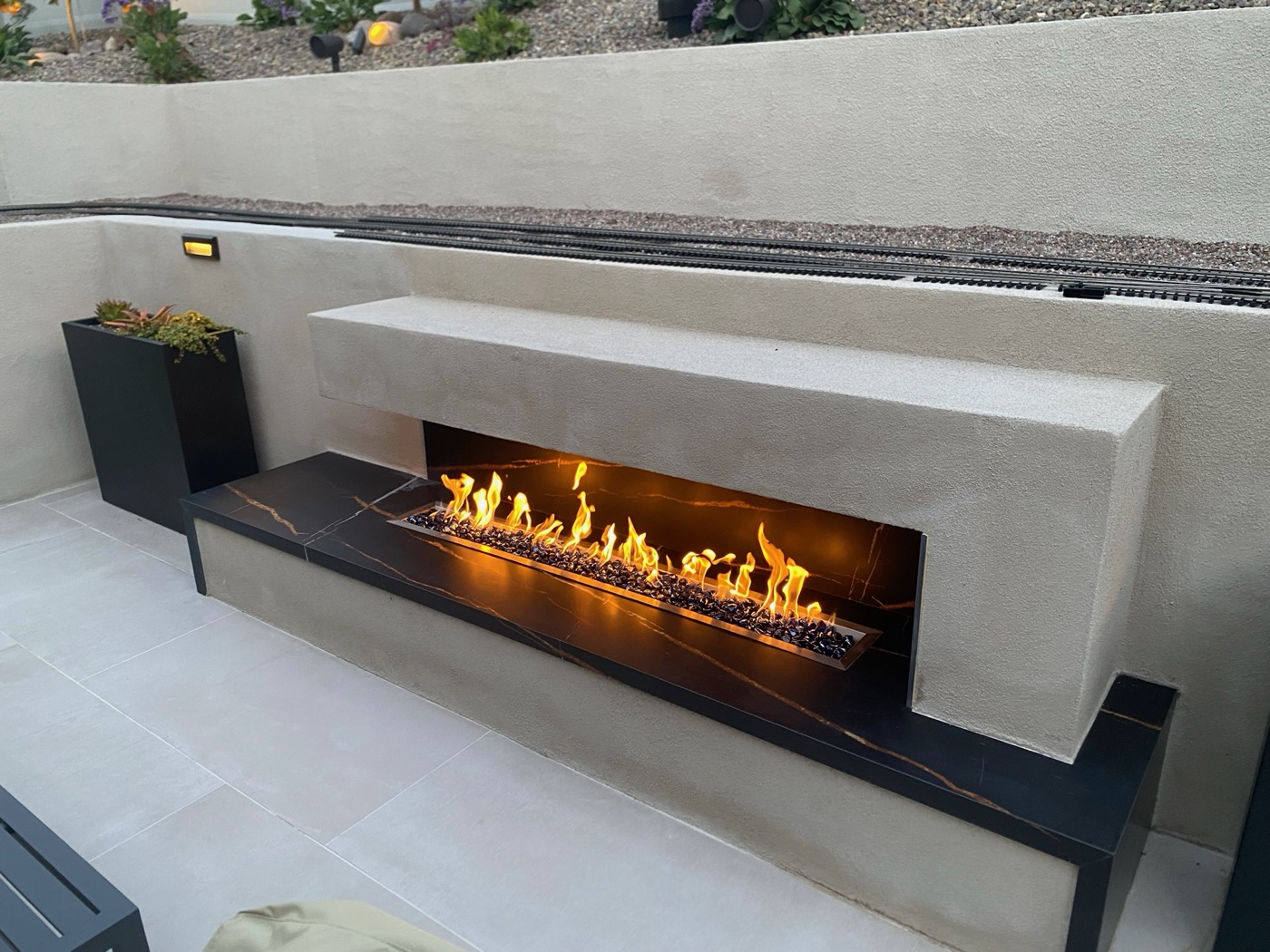 Linear fire feature with a porcelain surround in Youngsville by Abshire Brothers Lawn & Landscape
