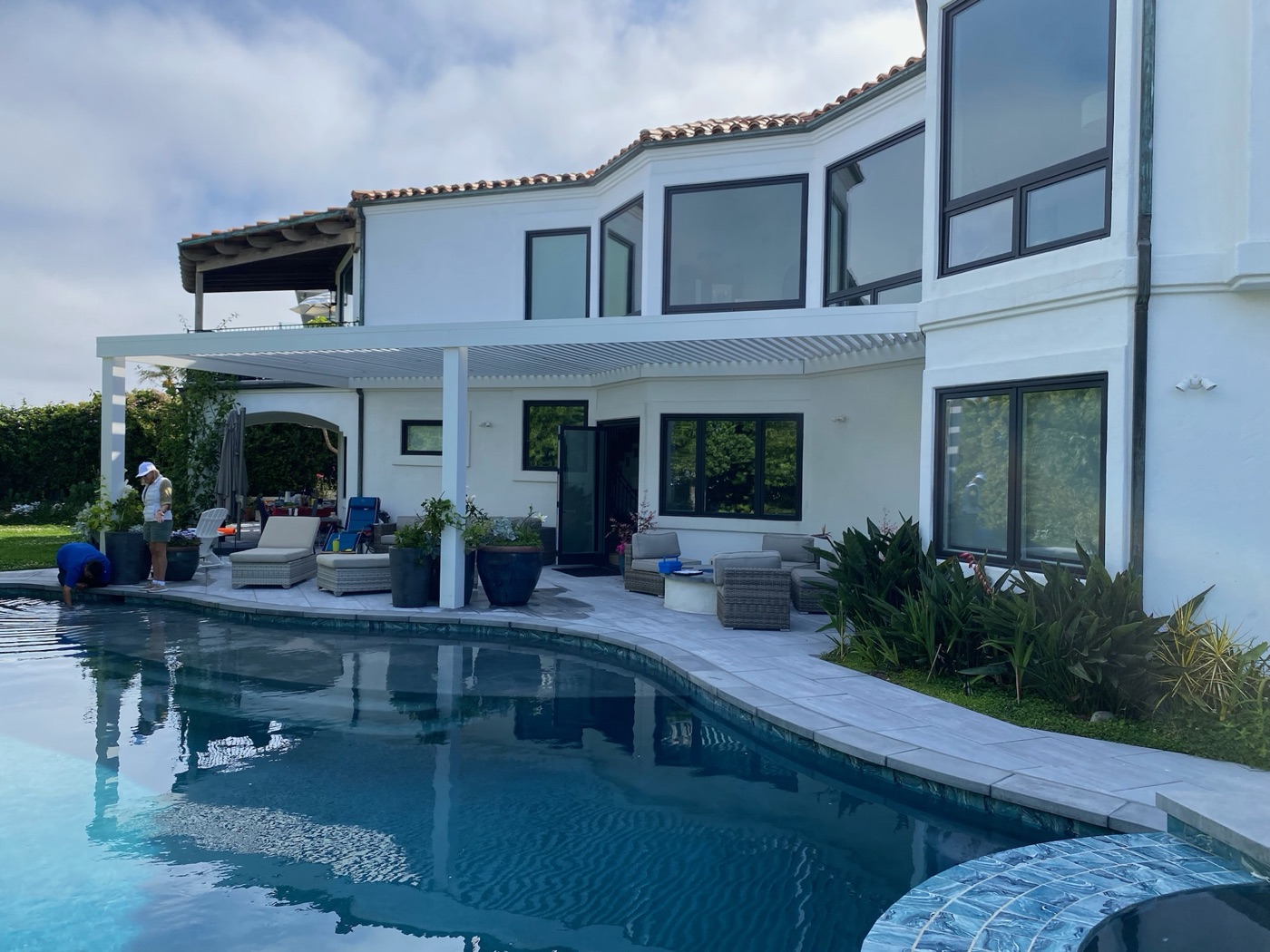 Modern pergola and pool at a Mediterranean estate in Crowley by Abshire Brothers Lawn & Landscape