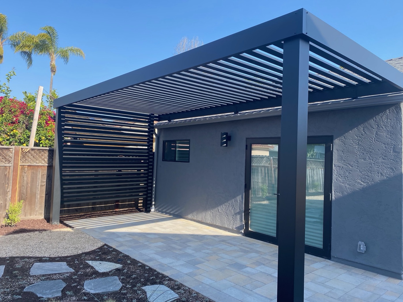 Louvered pergola over a paver patio in Broussard by Abshire Brothers Lawn & Landscape