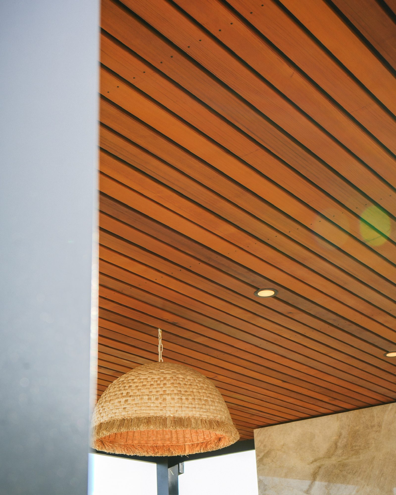 Clear-grain cedar inlay ceiling with a woven pendant light