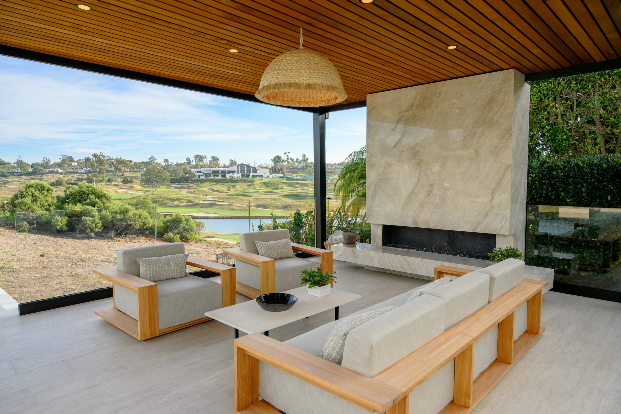 Quartzite fireplace and sectional in the covered patio facing the golf course