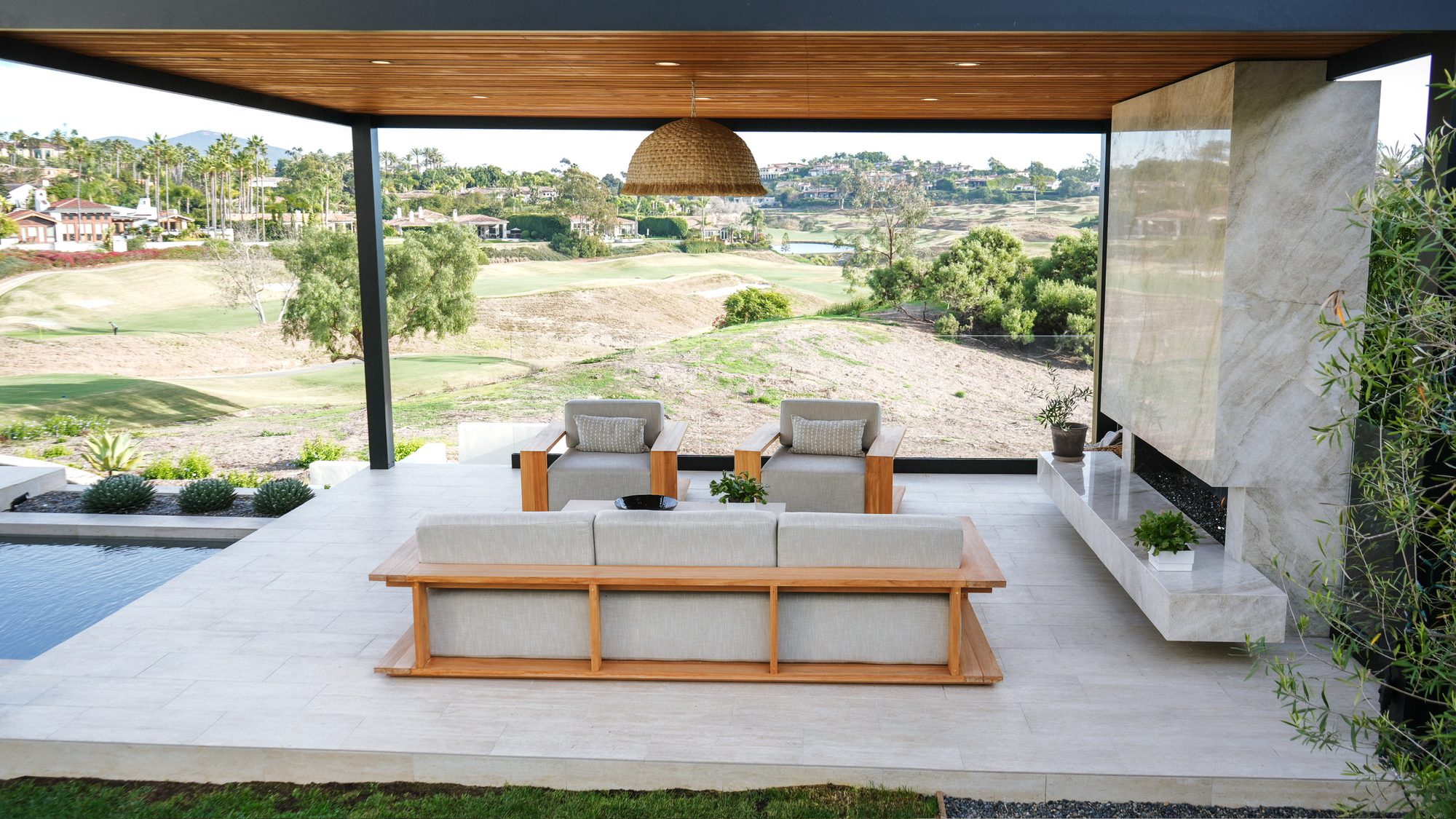 Covered patio with sectional seating and an open view over The Farms