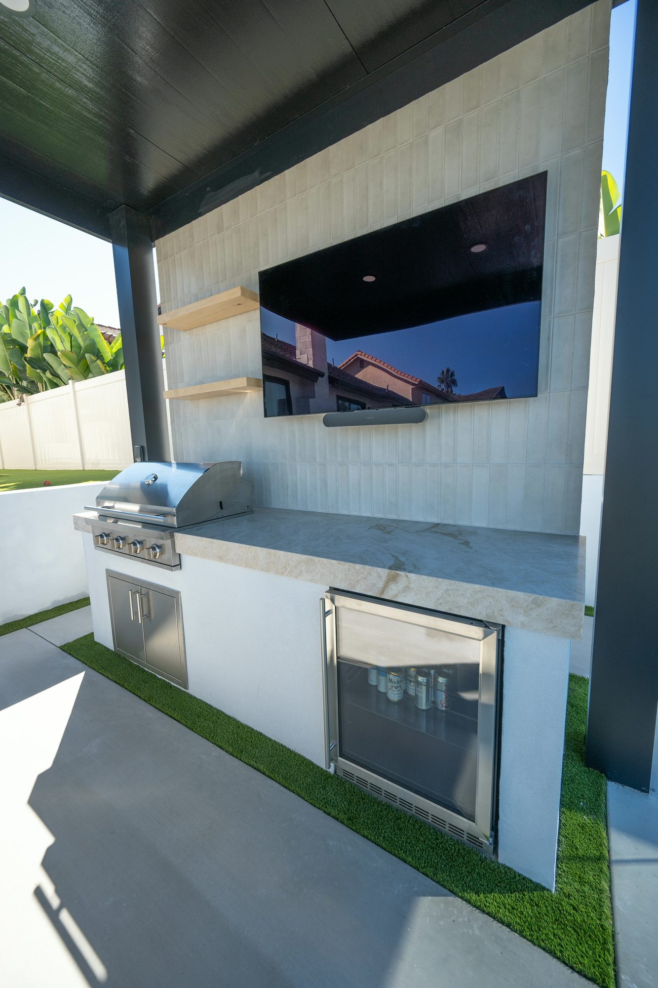 Built-in grill and quartzite counter beneath the integrated television