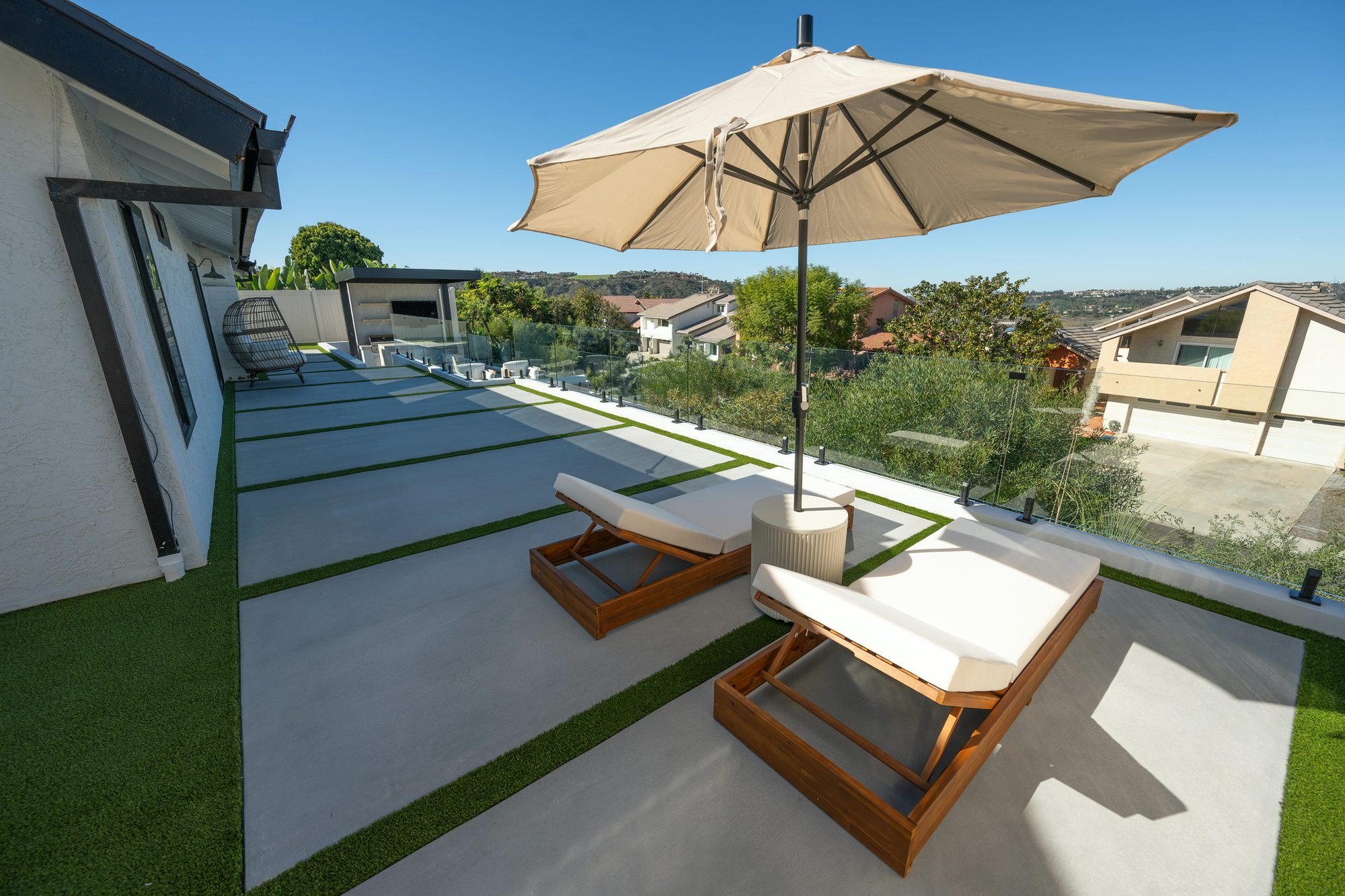 Lounger and umbrella beside the stepping-stone path down the yard