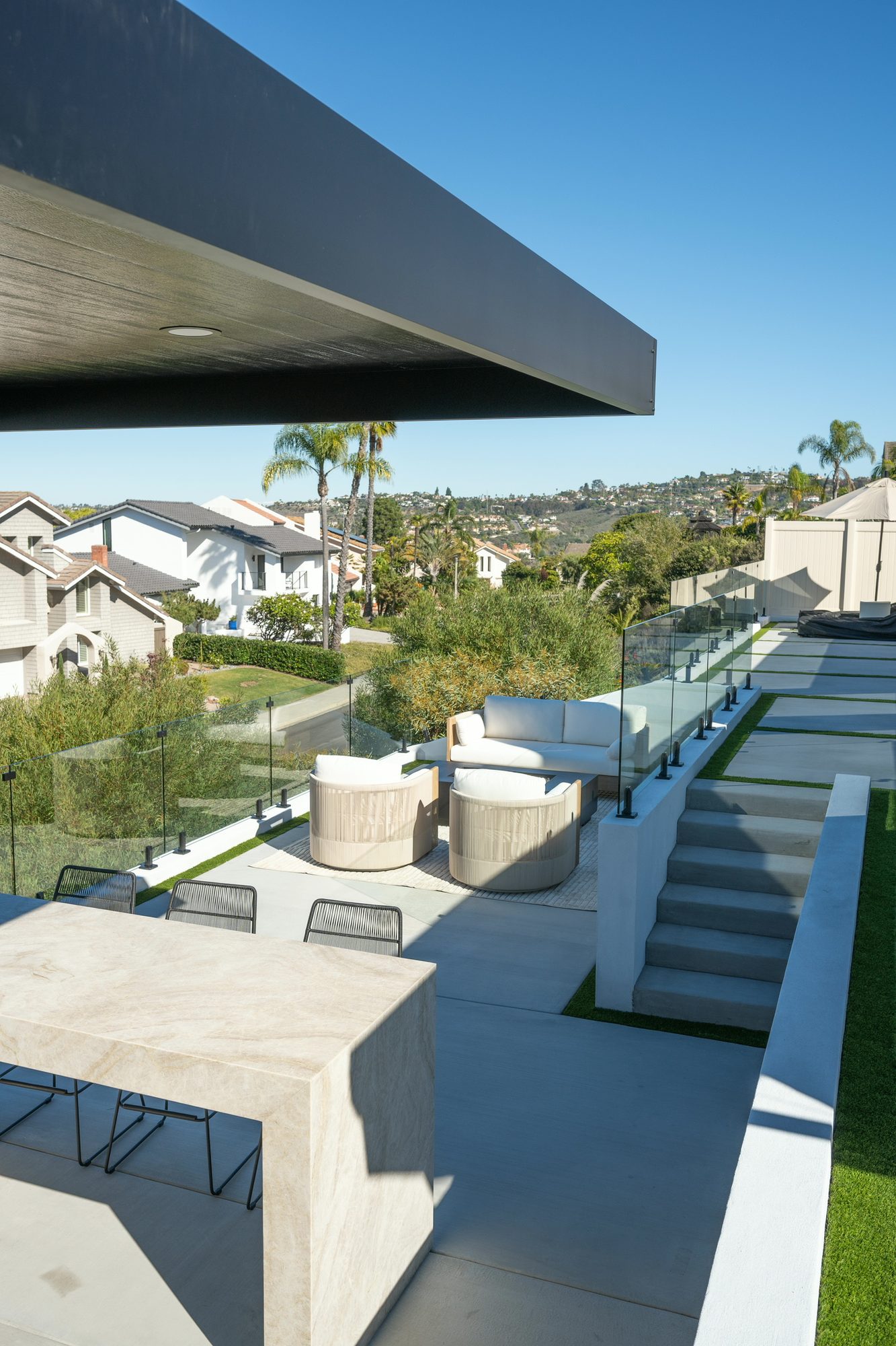 Long view down the multi-level yard with stepping stones and turf inlays