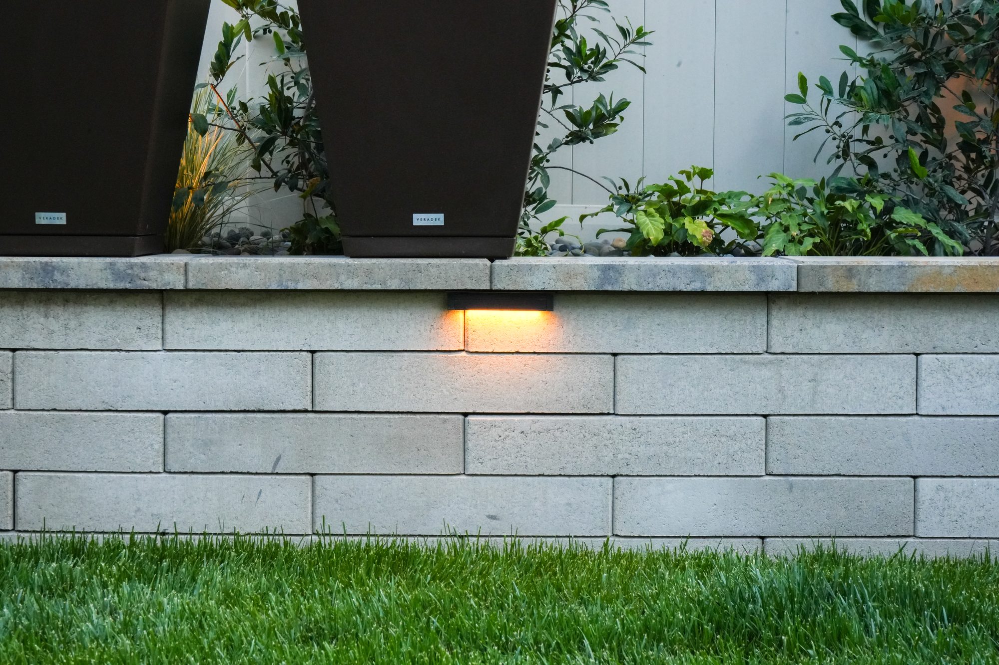 Melville-block raised planters with integrated lighting at dusk