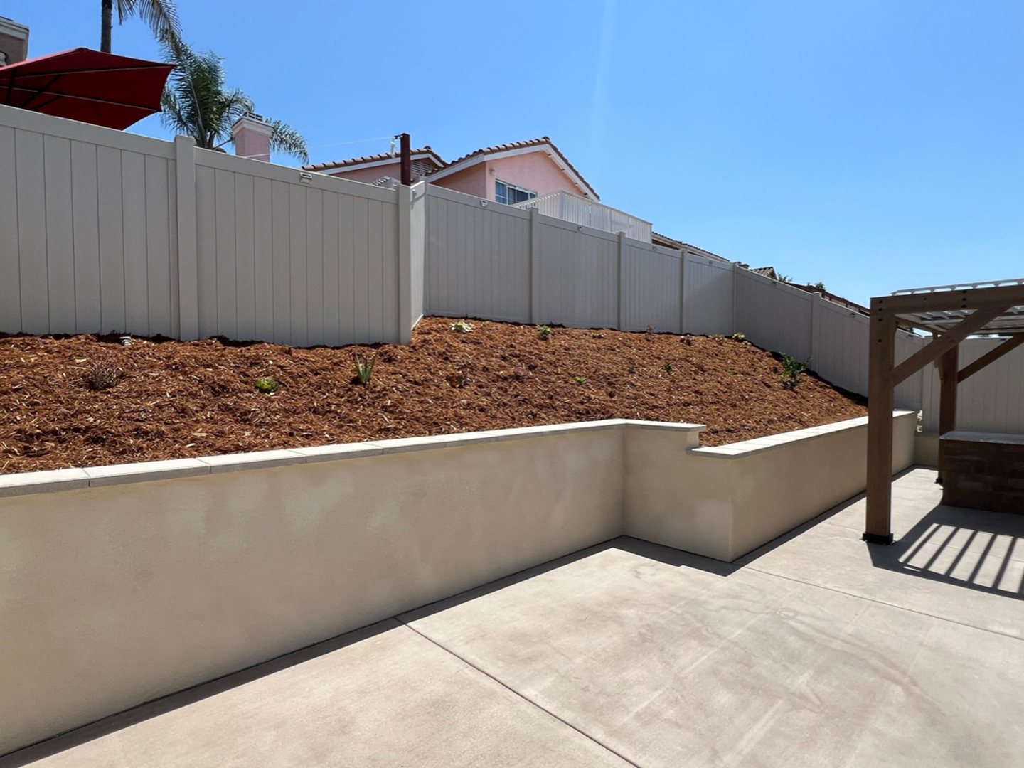 After: Slope Retaining Wall, Patio & Pergola